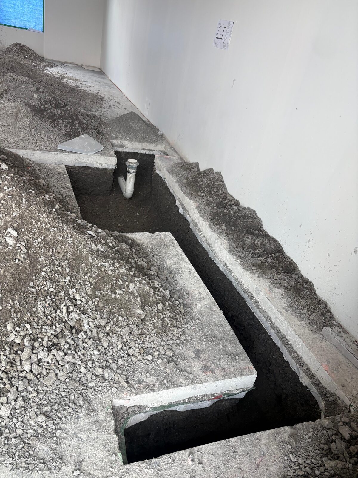 Drain line trenching in a commercial unit before slab pour