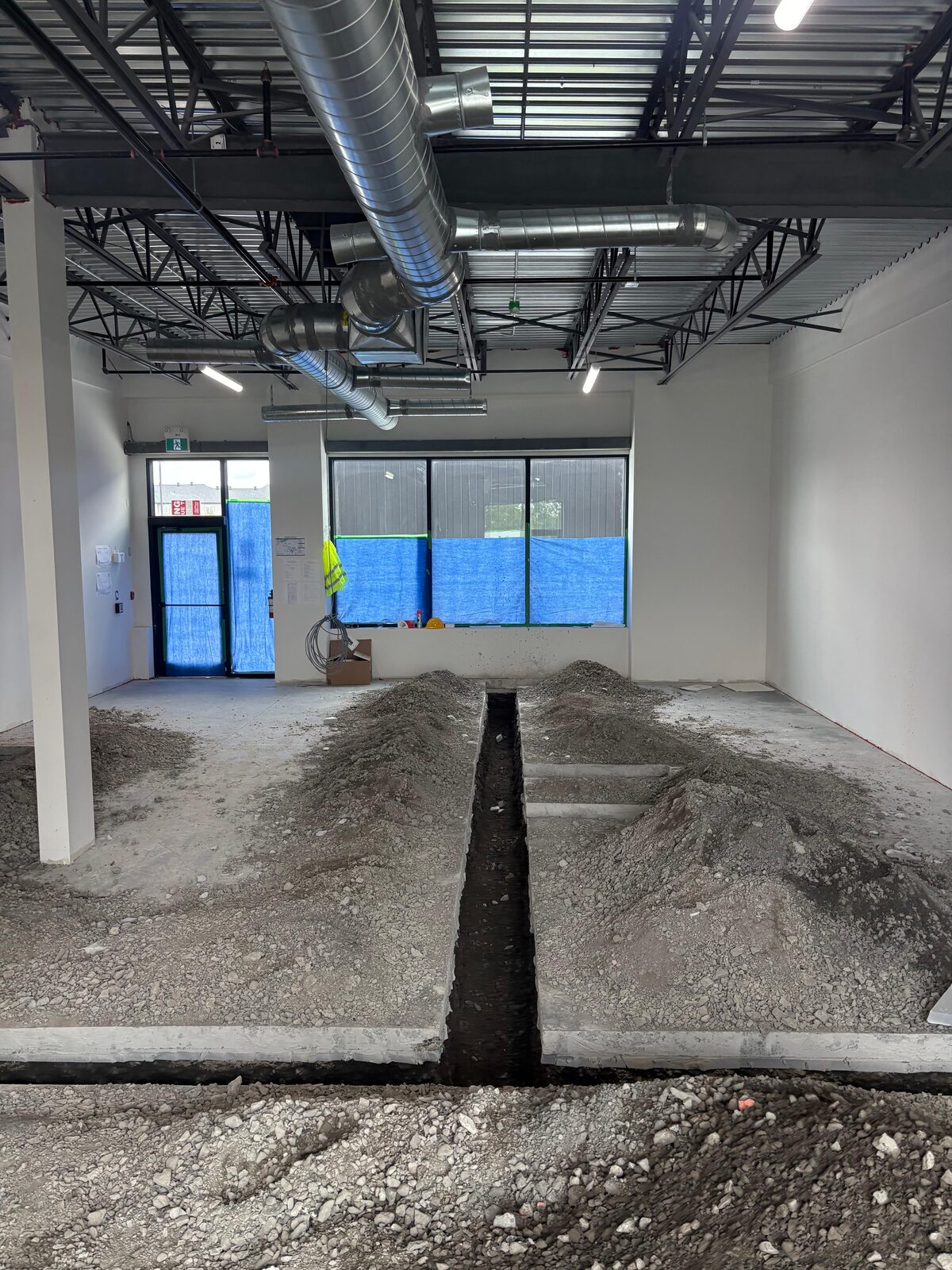 Underground waste line trench layout in a commercial build