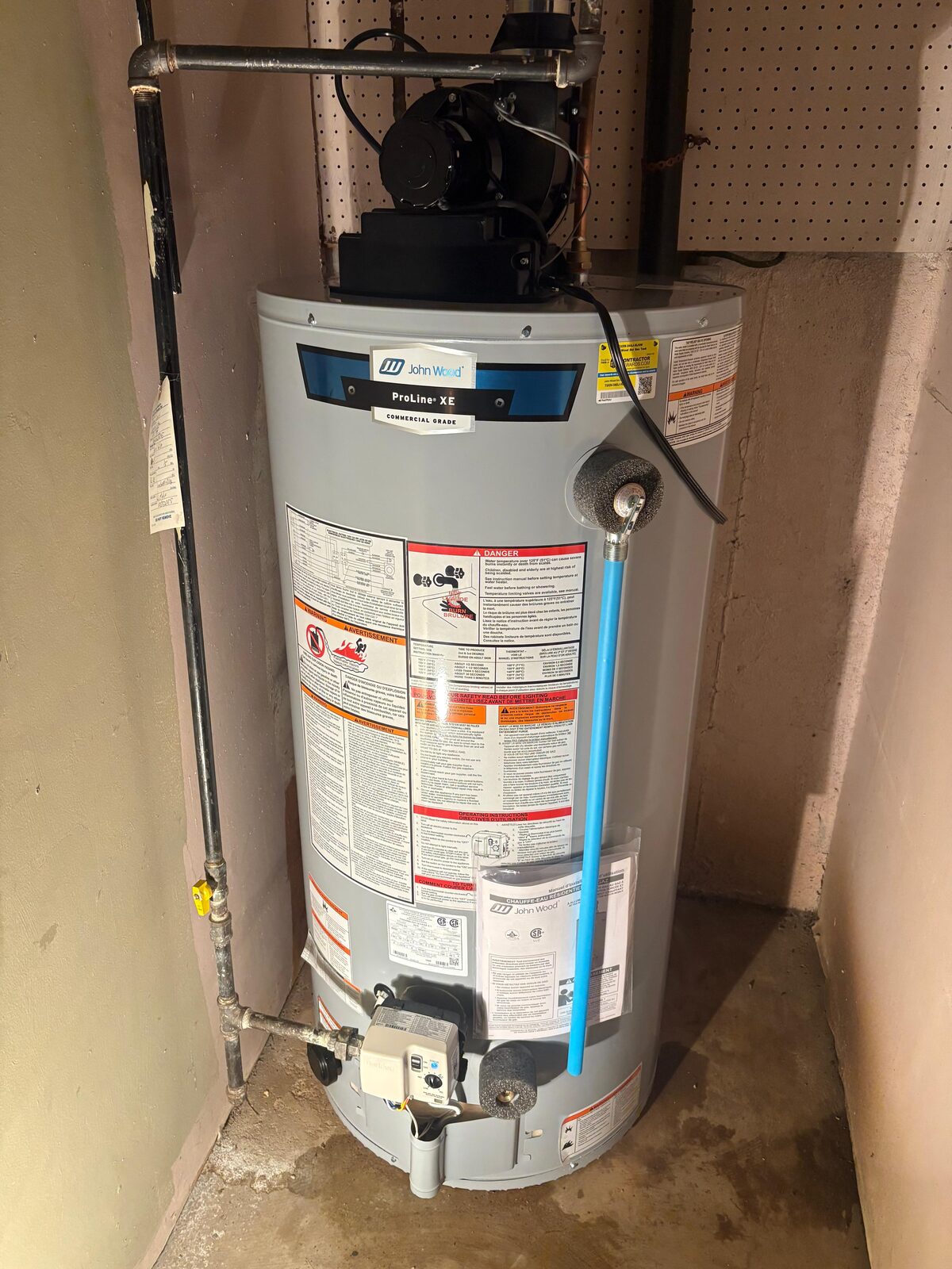 New gas water heater installed in a basement mechanical room
